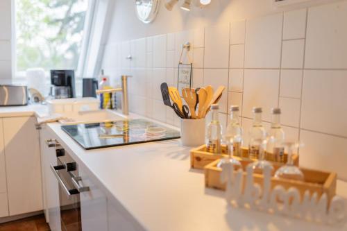 a kitchen counter with bottles and utensils on it at Gut Basthorst in Basthorst