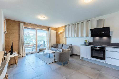 une cuisine et un salon avec un canapé et une table dans l'établissement Résidence L'ecrin - ECRIN B41 MAE-0091, à Arc 1800