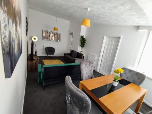 a living room with a couch and a table at Sigma Haven, Free Parking in Old Walker