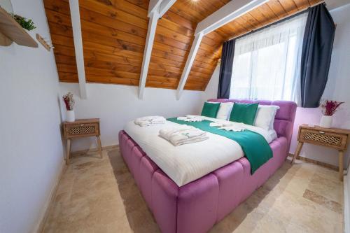 a purple bed in a room with a window at Grand Paradise Resort Sapanca in Sapanca