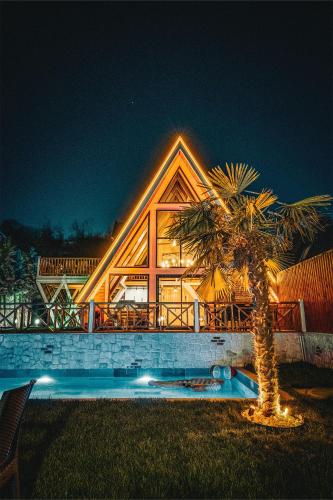 a large house with a palm tree in front of it at Grand Paradise Resort Sapanca in Sapanca