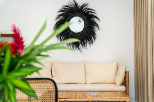 a living room with a couch and a mirror at Villa Primarosa - Charming 3BR Villa with rooftop in Munggu