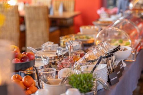 a buffet line with plates of food on a table at Gut Basthorst in Basthorst