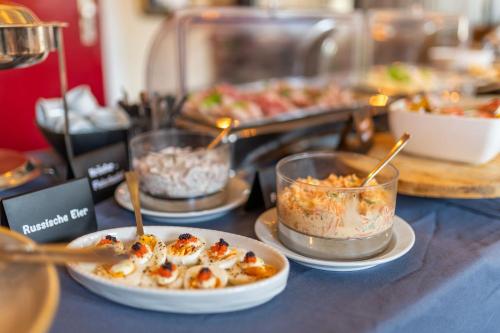 a buffet with plates of food on a table at Gut Basthorst in Basthorst