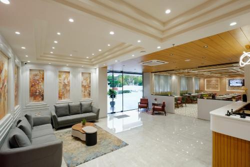 a lobby with couches and a bar in a building at Prarambh By Siara in Nadiad
