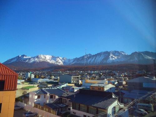 a city with snow capped mountains in the background at MIL810 Ushuaia Hotel in Ushuaia