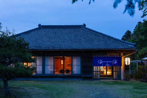 a building with a sign in front of it at 顔house 若水庵 築100年の古民家ステイ 北総の田園に佇む和の隠れ家 最大12名宿泊可 in Katori