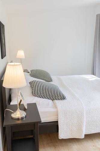a bedroom with a bed with a table and a lamp at Gut Basthorst in Basthorst