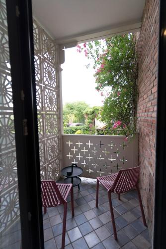 two chairs and a table on a patio at Amante Narikala Boutique Hotel in Tbilisi City