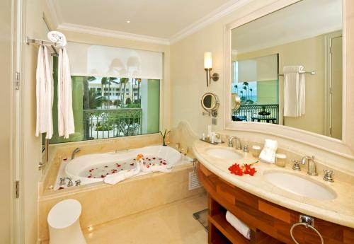 a bathroom with a tub and a sink at Iberostar Grand Bavaro Hotel in Punta Cana