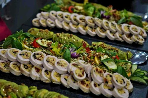 a row of plates of food on a table at Hotel Szieszta in Sopron