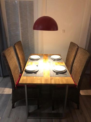 a wooden table with four chairs and a table and a table and chairsuggest at Guesthouse-Coburg 2 in Großheirath