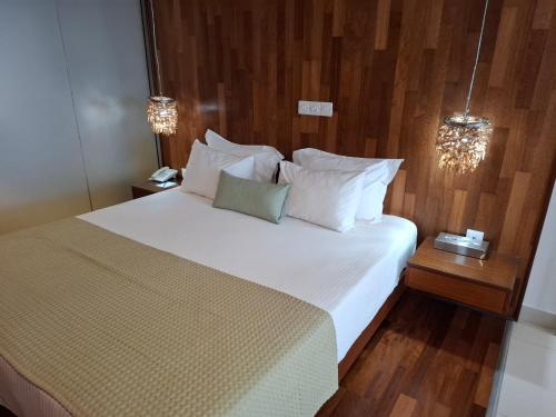 a bedroom with a large bed with white sheets and pillows at Napa Mermaid Hotel & Suites in Ayia Napa