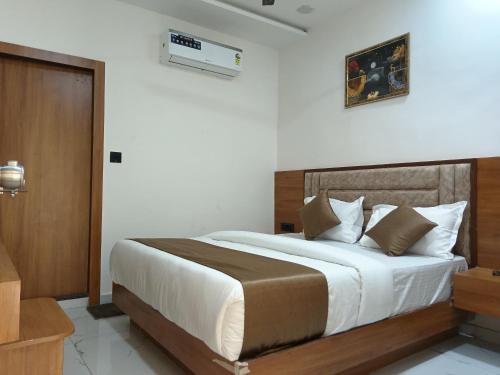a bedroom with a large bed in a room at Hotel Stay Zone in Ahmedabad