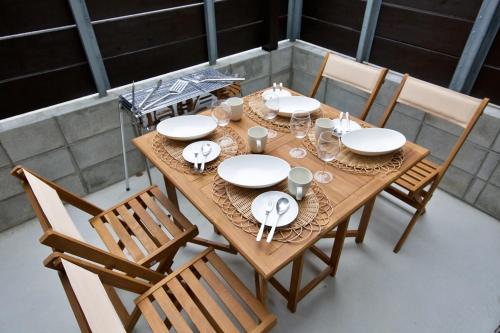 a wooden table with plates and dishes on it at Sole ONNA in Inbu