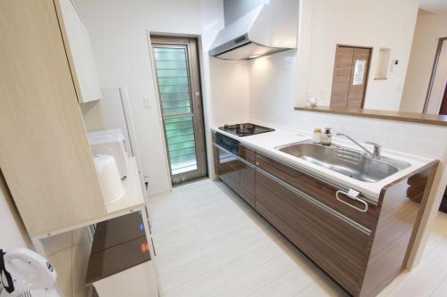 a small kitchen with a sink and a stove at Sole ONNA in Inbu