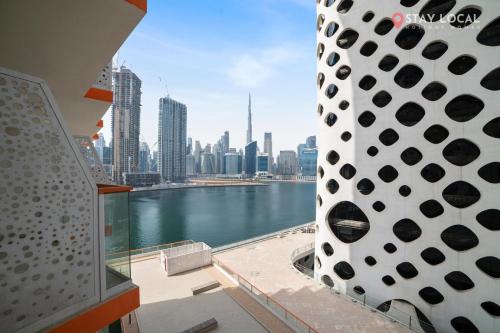 a view of a city skyline from a balcony at Stylish Escape with Balcony, Canal and Burj Khalifa Views Near Dubai Mall in Dubai