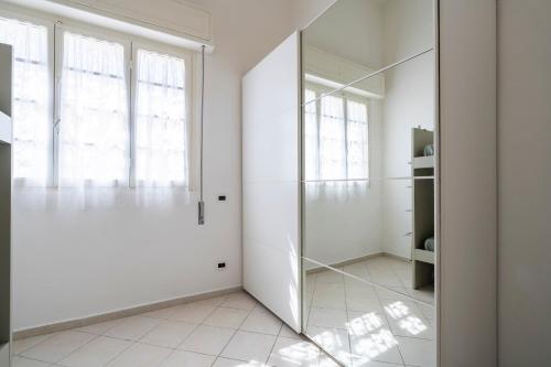 a room with white walls and a glass door at Appartamento Luxury vista mare in Lido di Camaiore