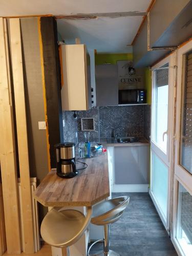 une petite cuisine avec une table et des chaises en bois dans l'établissement Le Floréal, à Niort