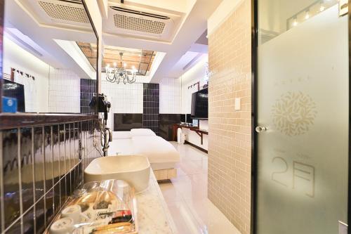 a bathroom with a sink and a mirror at Daegu February Hotel Hwanggeum in Daegu