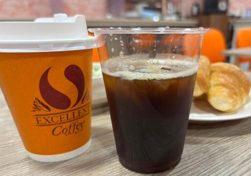 two cups of coffee and croissants on a table at APA Hotel Kagoshima Tenmonkan in Kagoshima
