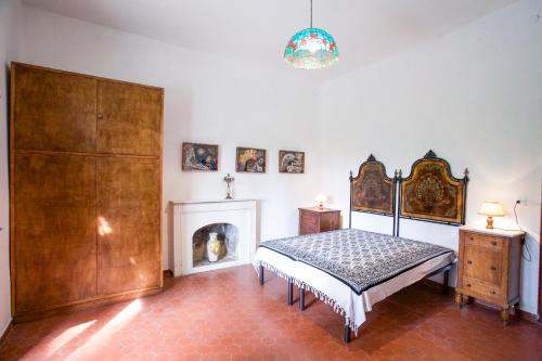 a bedroom with a bed and a fireplace at Appartamento Podere San Marco - Bilocale in Portoferraio