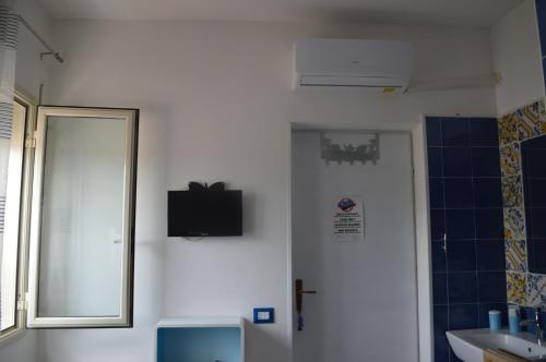 a bathroom with a mirror and a toilet and a sink at Il Pescatore in Marinella di Selinunte