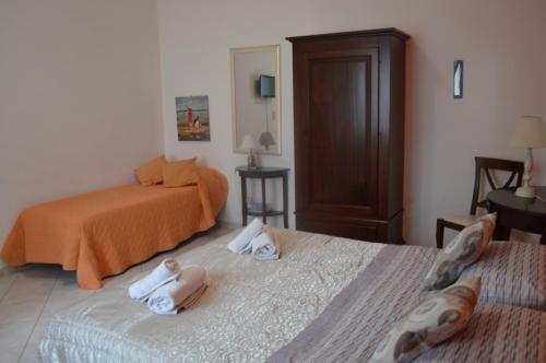 a bedroom with two beds with towels on them at Il Pescatore in Marinella di Selinunte