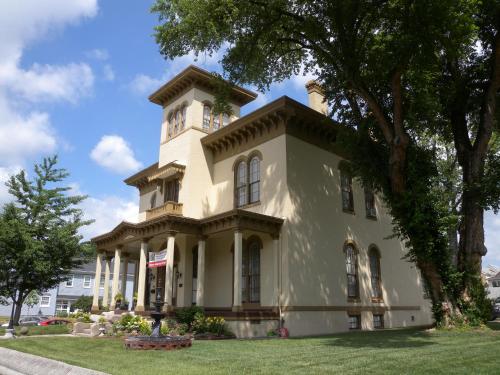 a building with a clock tower on top of it at The Pepin Mansion B&B on Mansion Row - 10 min to start of the Bourbon Trail in New Albany