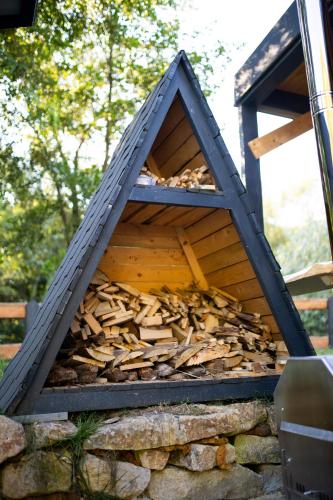 a pile of fire wood in a wooden structure at A-Park Bologa in Bologa