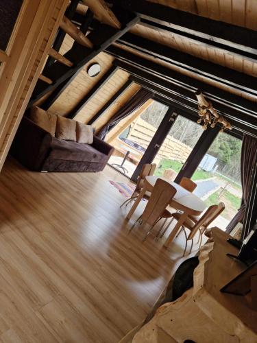 a room with a table and chairs and a large window at A-Park Bologa in Bologa