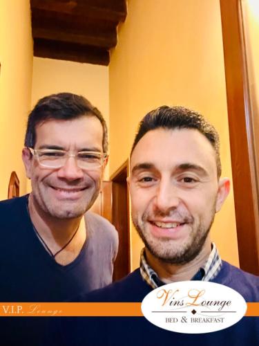 two men are smiling for a picture at VinsLounge Suite in Barletta
