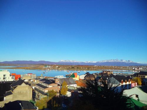 a city with a river and mountains in the background at MIL810 Ushuaia Hotel in Ushuaia
