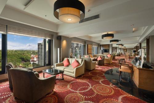 a hotel lobby with couches and chairs and a large window at Shangri-La Chiang Mai in Chiang Mai