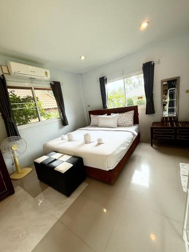 a large bedroom with a large bed and windows at Wandee Resort Bankrut in Ban Krut