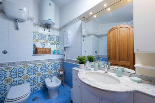 a bathroom with a sink and a toilet at Sea Whisper Home -Sunset, Sea, Easy Stay, Shops in Praiano