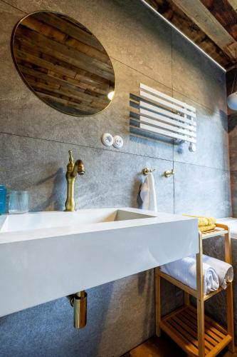 a bathroom with a sink and a mirror at Búda 2 in Komjatná