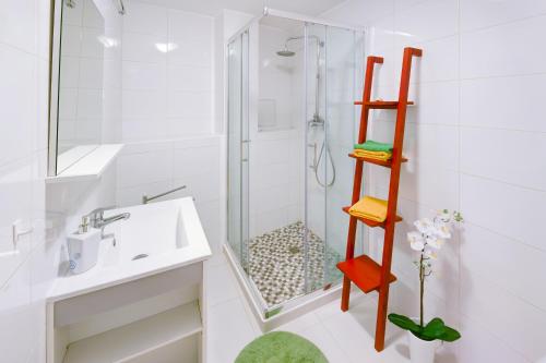 a white bathroom with a shower and a sink at Apartment Istra in Poreč