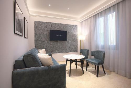 a living room with a couch and chairs and a table at Eurostars Laietana in Barcelona