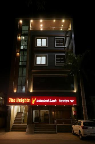 a building with a sign that reads the nights illuminated bank at Hotel The Heights in Haridwār