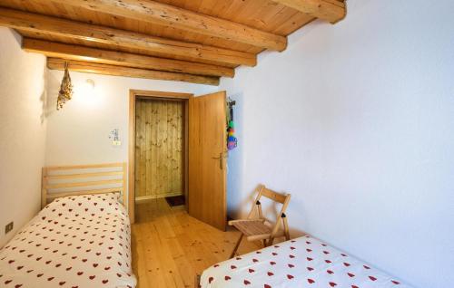 a bedroom with a bed and a wooden ceiling at 2 Bedroom Cozy Apartment In Arsiè in Arsiè