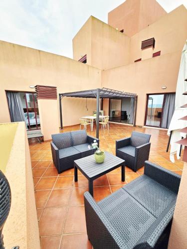 a patio with couches and tables on a building at CN-340 Suites in Estepona