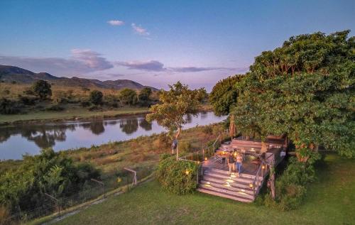an aerial view of a river with a group of tables at Kambaku River Lodge in Malelane