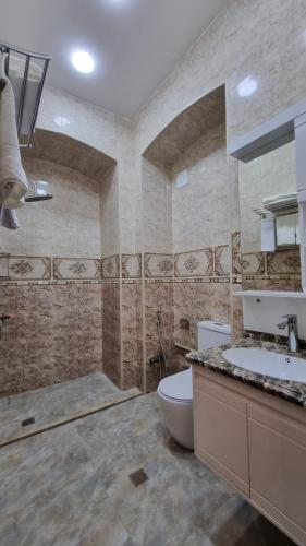 a large bathroom with a toilet and a sink at Grandview Boutique Hotel in Baku