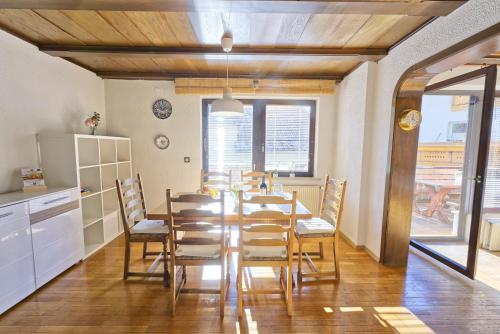 a kitchen and dining room with a table and chairs at Castle way Apartments Tamy in Bled