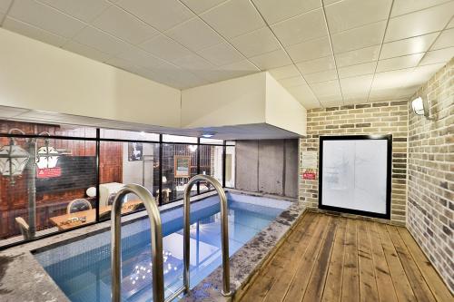 a large swimming pool in a building with a sign at Daegu February Hotel Hwanggeum in Daegu