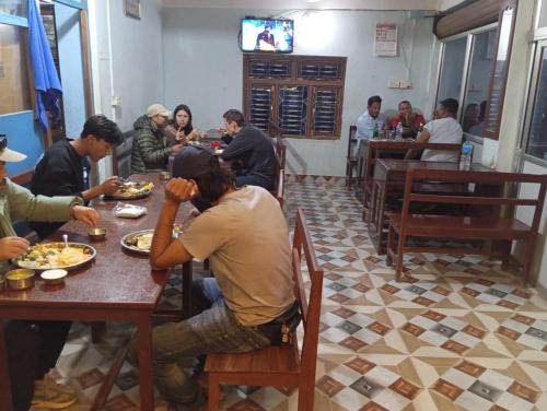 a group of people sitting at a table in a restaurant at B N Hotel & Restaurant in Rāmechhāp