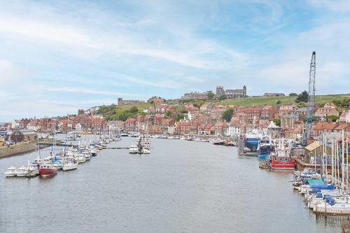 a bunch of boats are docked in a harbor at Host & Stay - Starboard Bow in Whitby