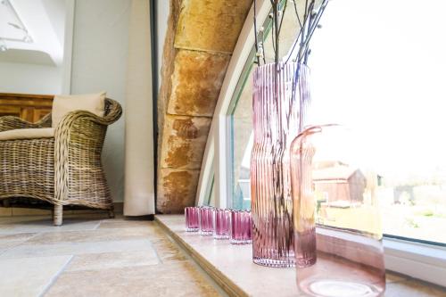 a group of glass vases sitting on a window sill at Hofgut Dösterhof - Hotelzimmer in Wadern