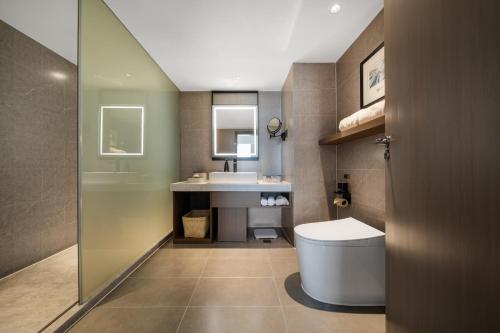 a bathroom with a toilet and a sink at Atour Hotel Chengdu Taikoo Li Riverside in Chengdu